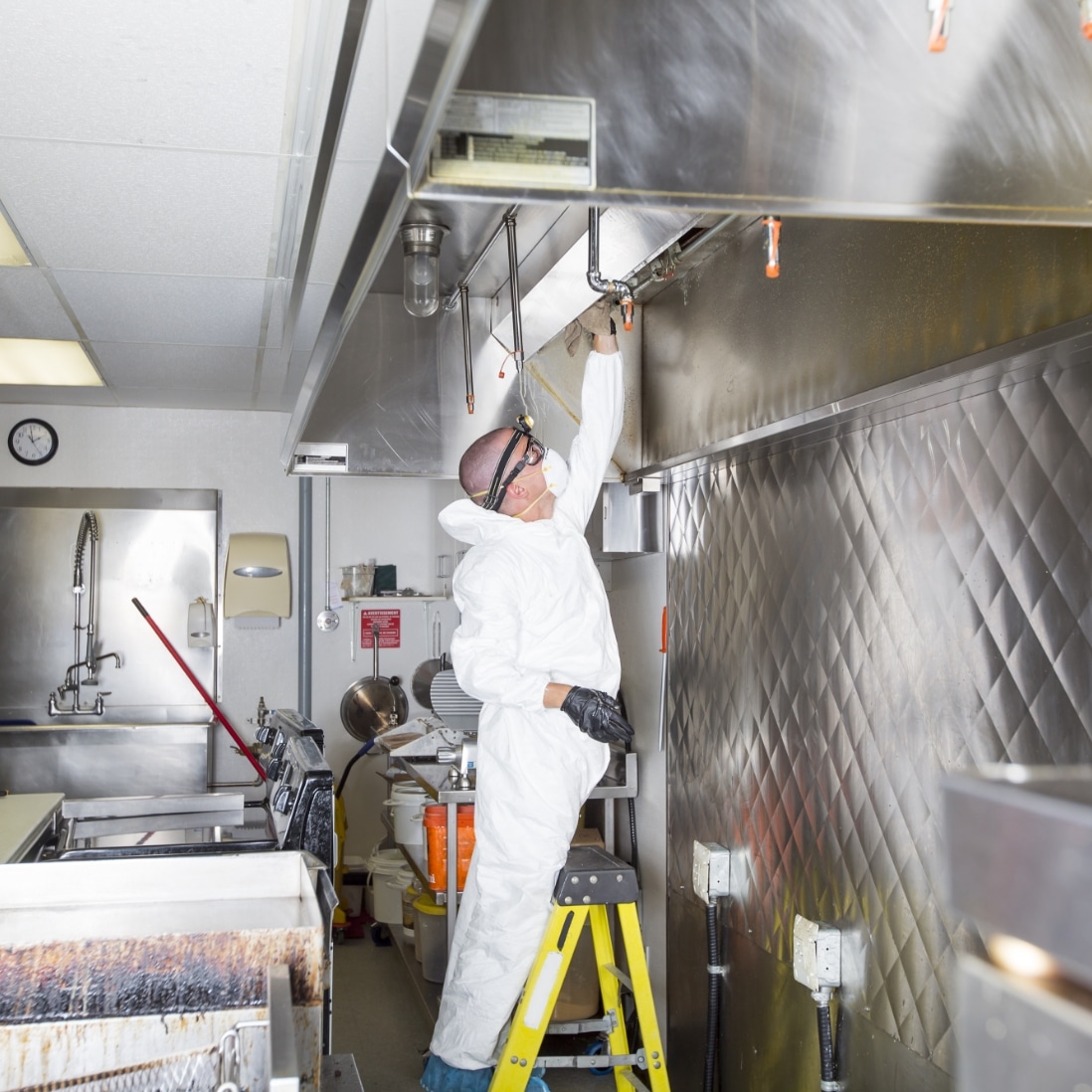 Technician maintaining commercial kitchen equipment